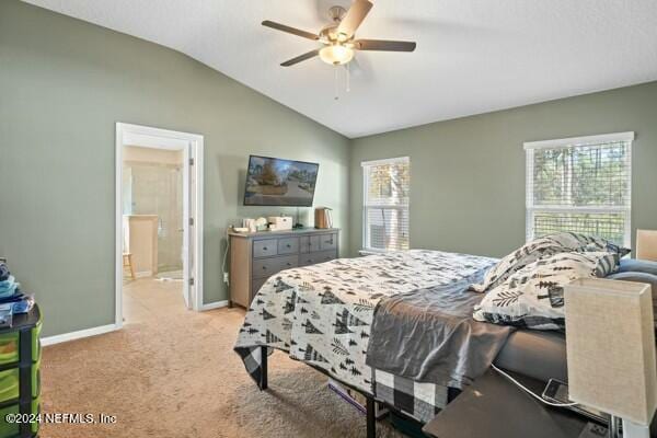 carpeted bedroom with multiple windows, ceiling fan, and lofted ceiling