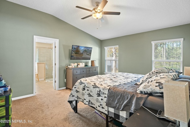 carpeted bedroom with lofted ceiling, ceiling fan, ensuite bath, and a textured ceiling