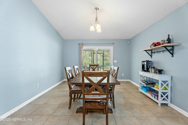 dining space with a notable chandelier and light tile patterned floors