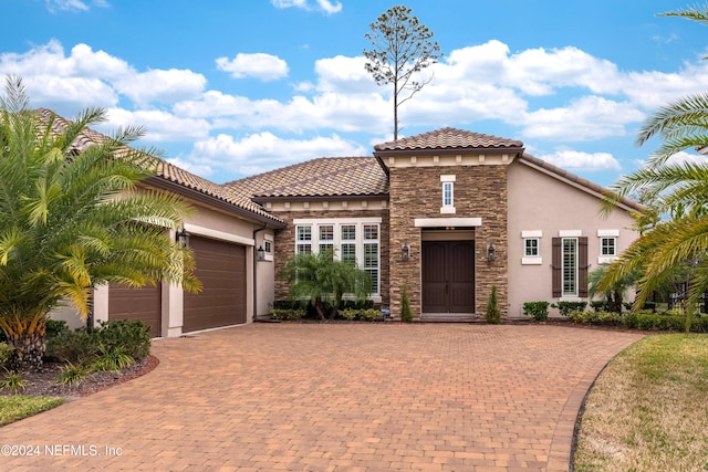 mediterranean / spanish-style house with a garage