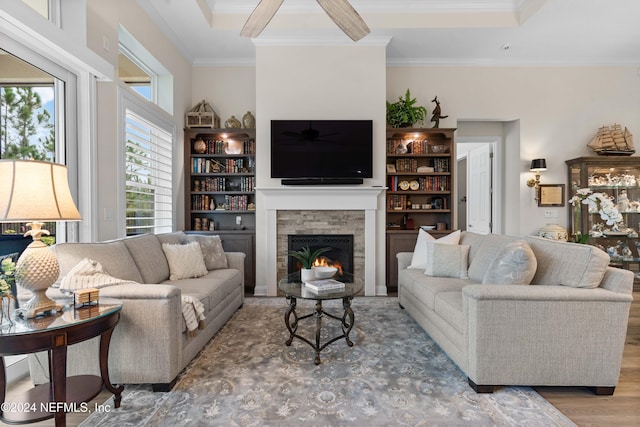 living room with crown molding, a fireplace, and hardwood / wood-style floors