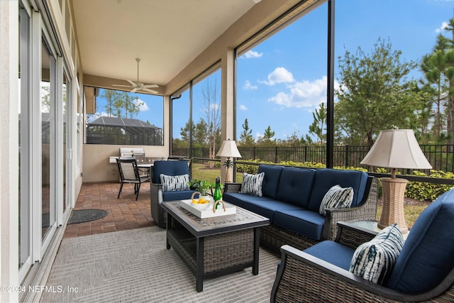 sunroom featuring ceiling fan