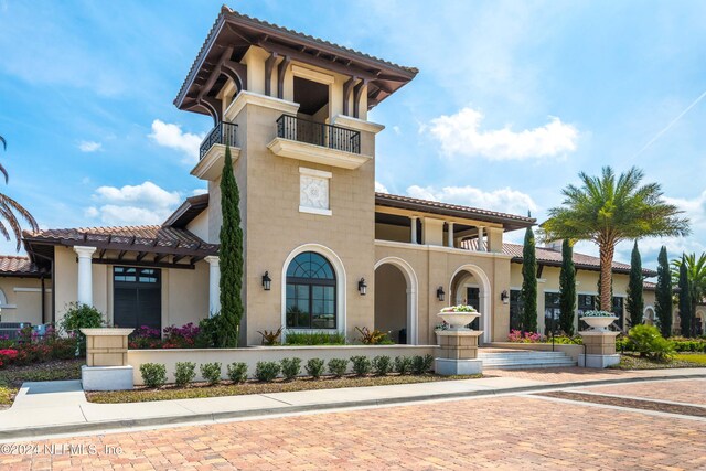 mediterranean / spanish home with a balcony