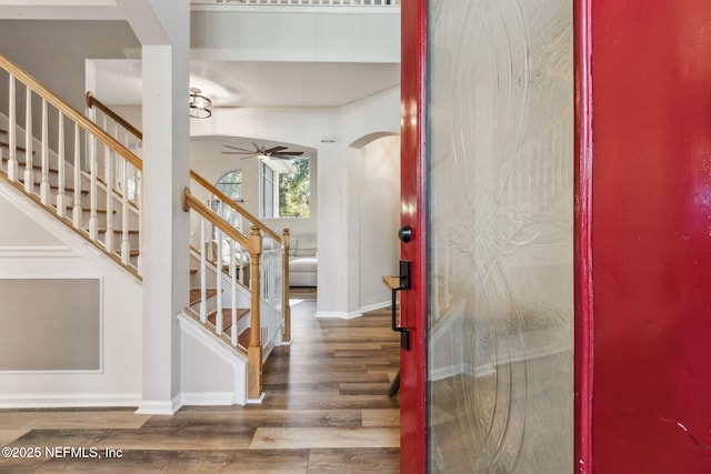 entryway with wood-type flooring and ceiling fan