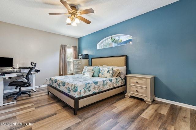 bedroom with hardwood / wood-style floors and ceiling fan