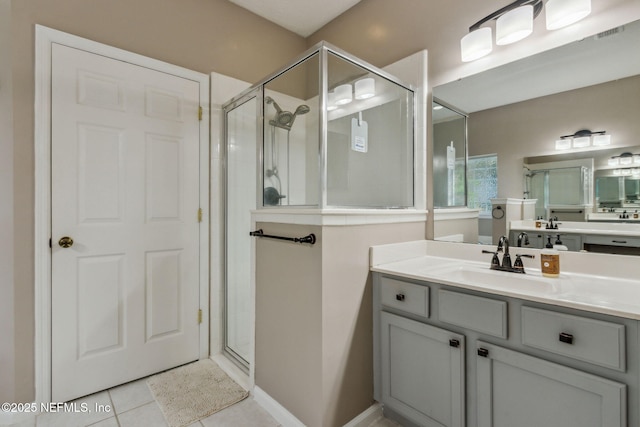 bathroom with tile patterned floors, vanity, and an enclosed shower