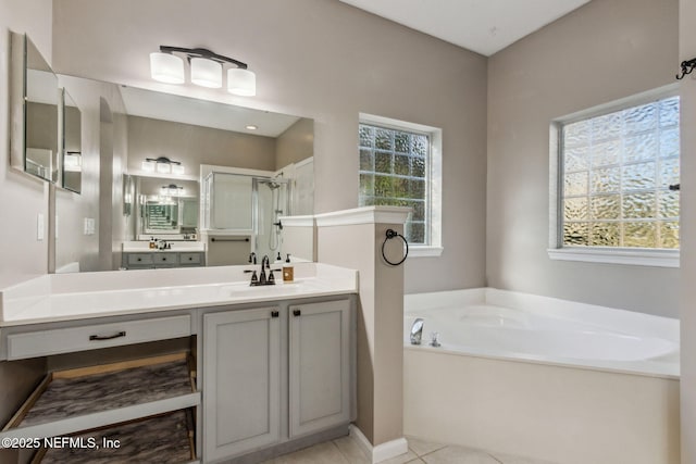 bathroom with tile patterned flooring, vanity, and shower with separate bathtub