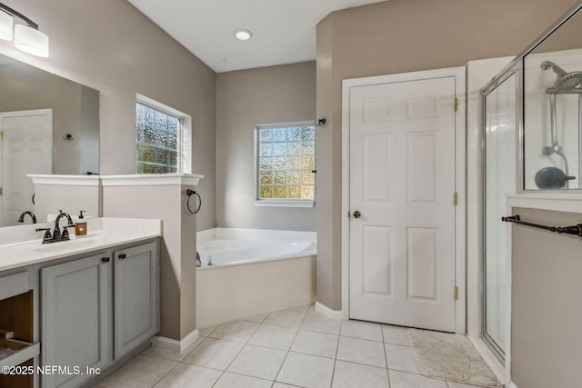 bathroom featuring tile patterned floors, vanity, and separate shower and tub