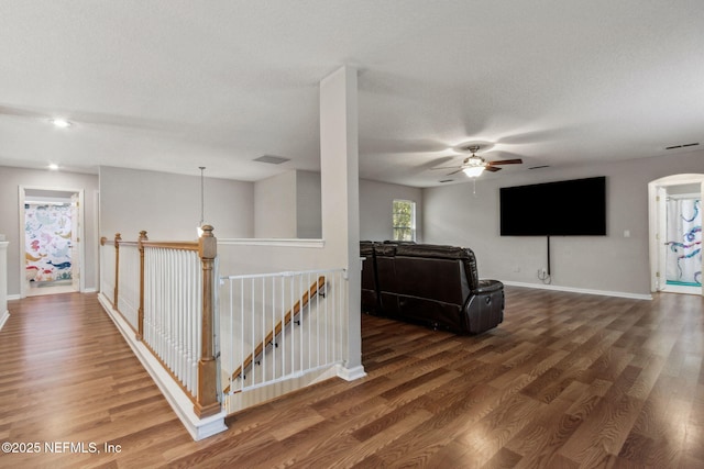 living room featuring a textured ceiling and dark wood-type flooring