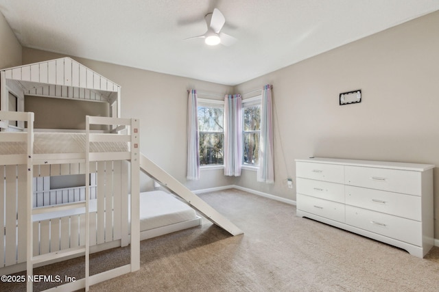 unfurnished bedroom featuring ceiling fan and light colored carpet