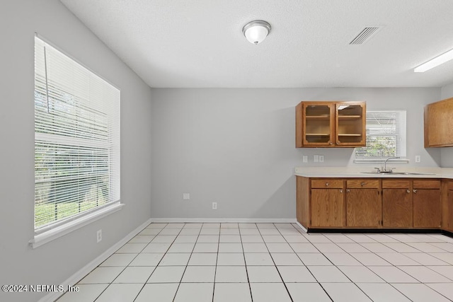 kitchen featuring light tile patterned flooring and sink