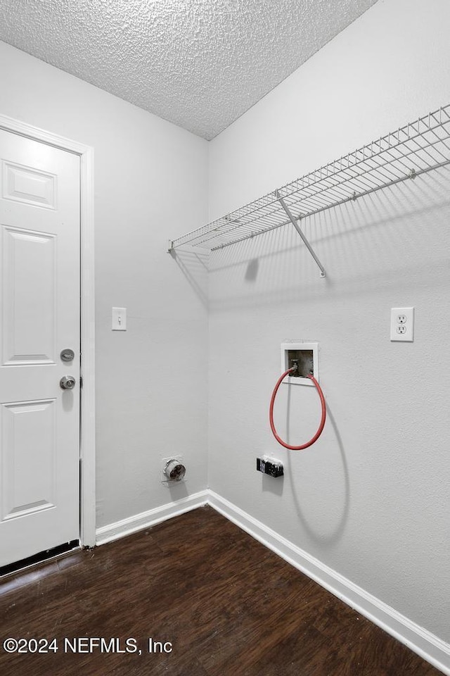 laundry area with hardwood / wood-style flooring, a textured ceiling, and hookup for a washing machine