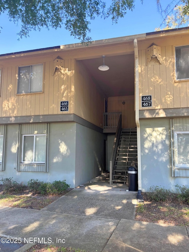 view of property featuring stairway