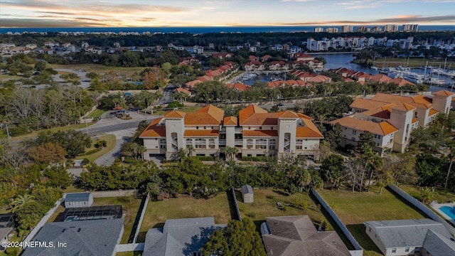 aerial view at dusk with a water view