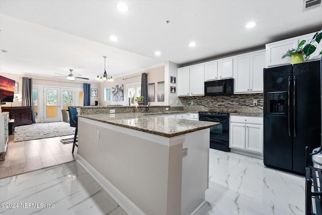 kitchen featuring kitchen peninsula, white cabinetry, black appliances, and ceiling fan with notable chandelier