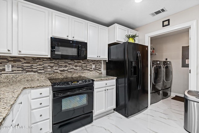 kitchen with washing machine and clothes dryer, light stone counters, decorative backsplash, white cabinets, and black appliances