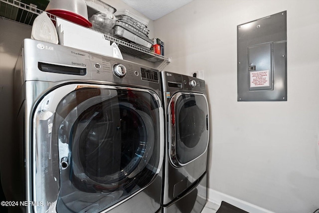 laundry area featuring electric panel and washing machine and dryer