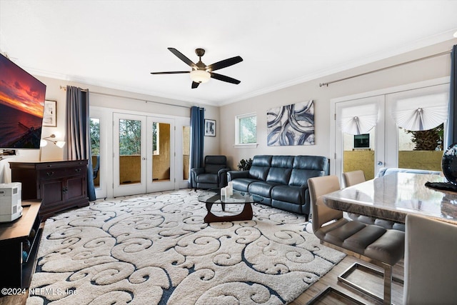 living room with plenty of natural light, ornamental molding, and french doors