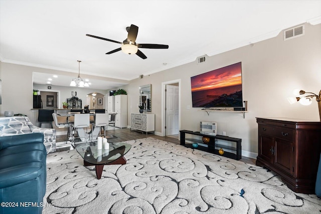 living room with crown molding, ceiling fan with notable chandelier, and light wood-type flooring