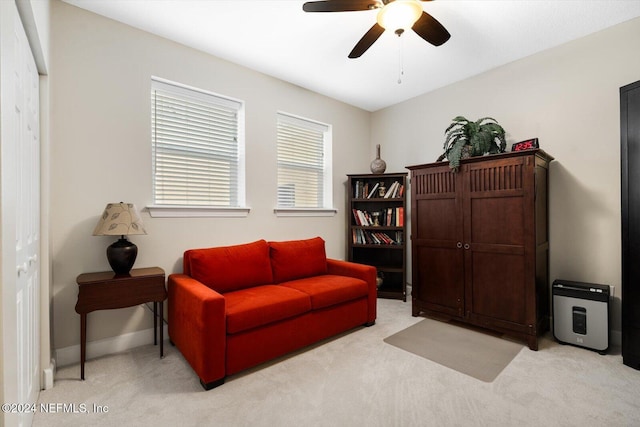 sitting room with light colored carpet and ceiling fan