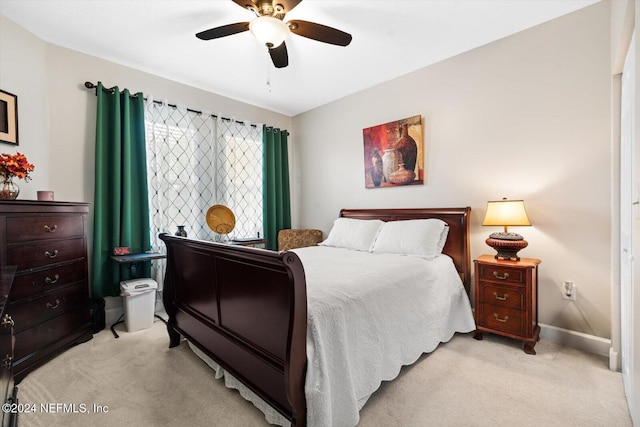 bedroom with light colored carpet and ceiling fan