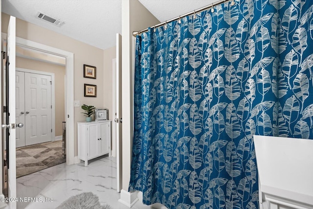 bathroom with a textured ceiling