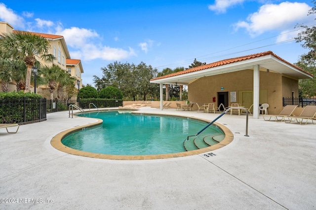 view of swimming pool with a patio