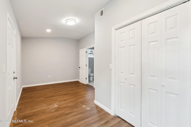 hallway with hardwood / wood-style floors