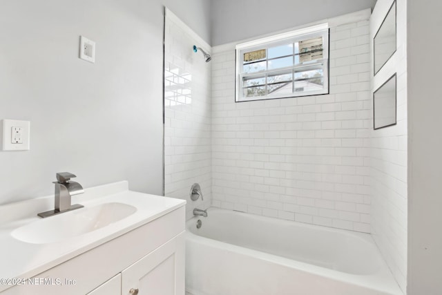 bathroom featuring vanity and tiled shower / bath combo