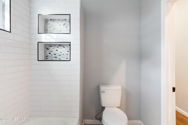 bathroom featuring hardwood / wood-style floors and toilet