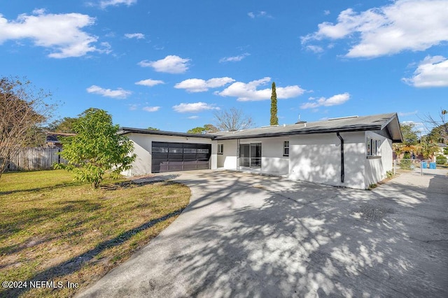 view of front of property with a front lawn and a garage