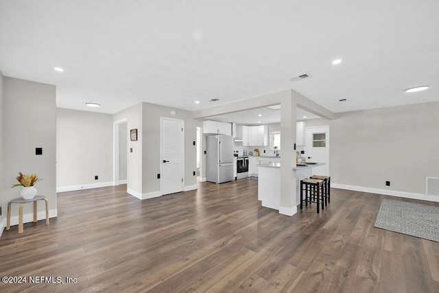 living room with dark hardwood / wood-style flooring