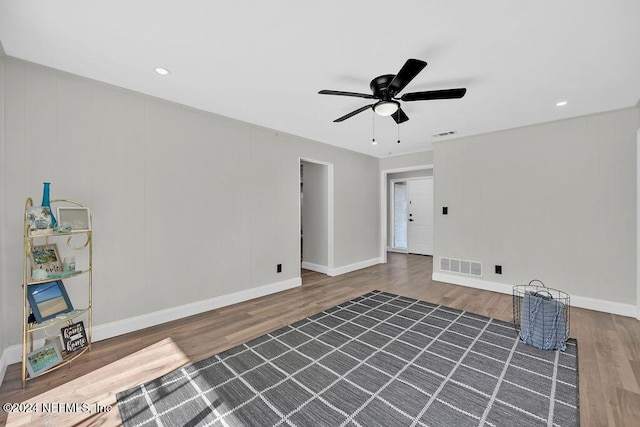 unfurnished room with ceiling fan and dark wood-type flooring