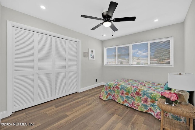 bedroom with ceiling fan, a closet, and wood-type flooring