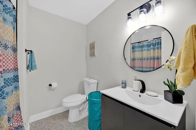 bathroom featuring tile patterned floors, vanity, toilet, and curtained shower