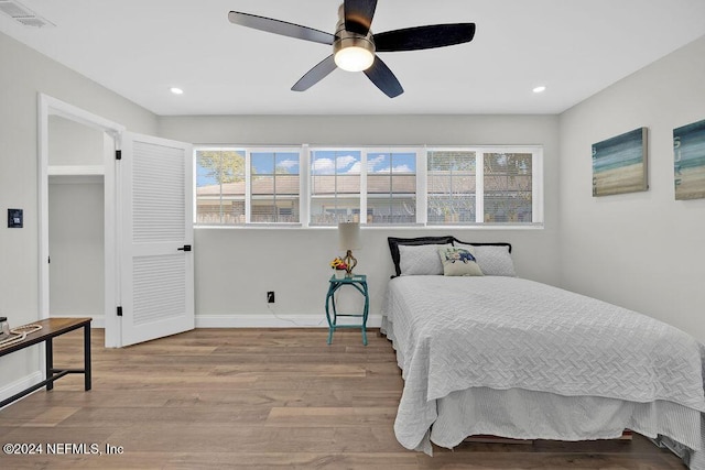 bedroom with light hardwood / wood-style flooring and ceiling fan