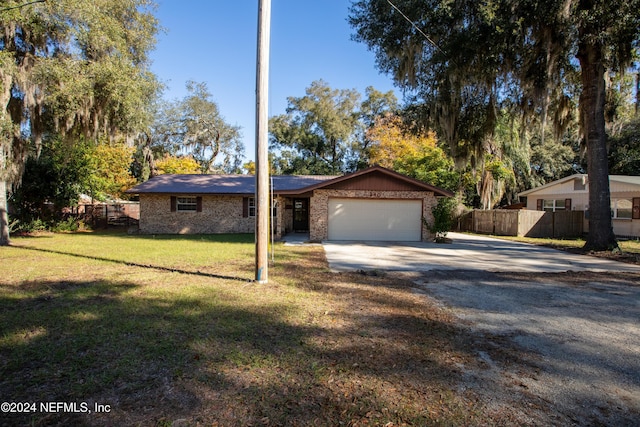 ranch-style home featuring a front yard and a garage