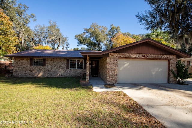 ranch-style house featuring a front lawn and a garage