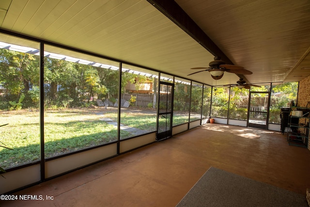 unfurnished sunroom featuring ceiling fan