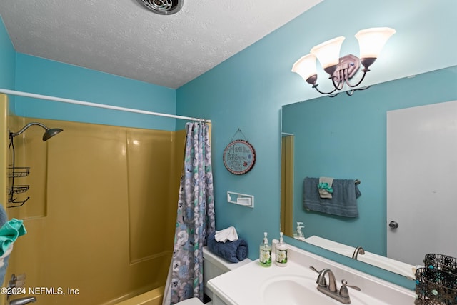 full bathroom with vanity, shower / tub combo, a textured ceiling, and toilet