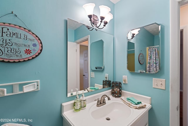 bathroom featuring vanity and an inviting chandelier