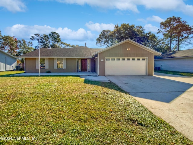 ranch-style house with a garage and a front lawn