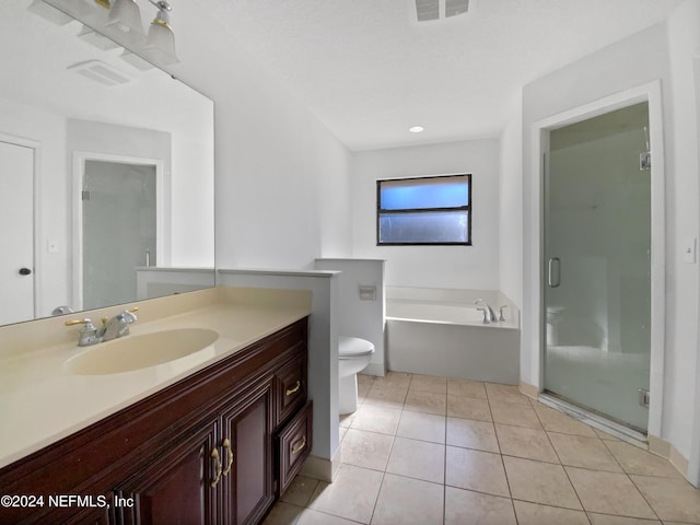 full bathroom with tile patterned floors, vanity, shower with separate bathtub, and toilet