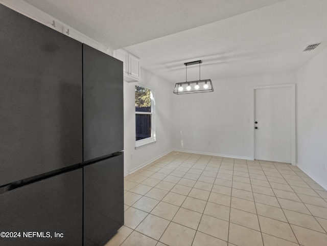 unfurnished dining area with light tile patterned floors