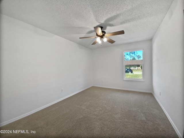 unfurnished room featuring ceiling fan, carpet floors, and a textured ceiling