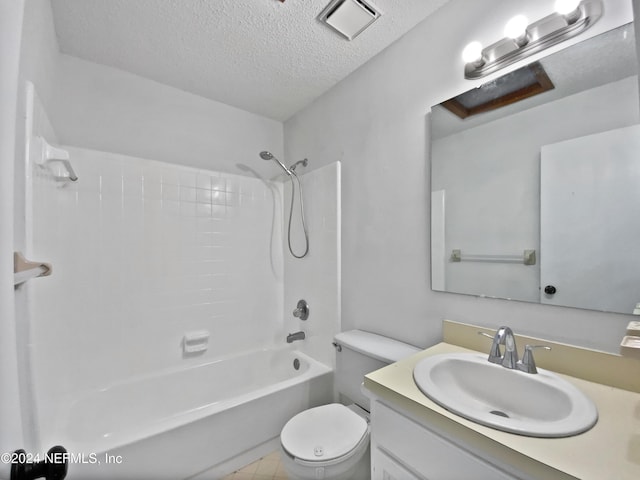 full bathroom with tile patterned floors, vanity, a textured ceiling, washtub / shower combination, and toilet