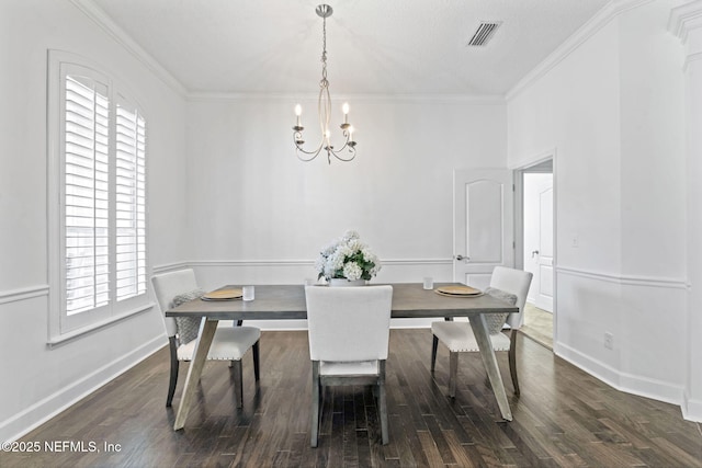 dining room featuring crown molding, dark wood-type flooring, and a chandelier