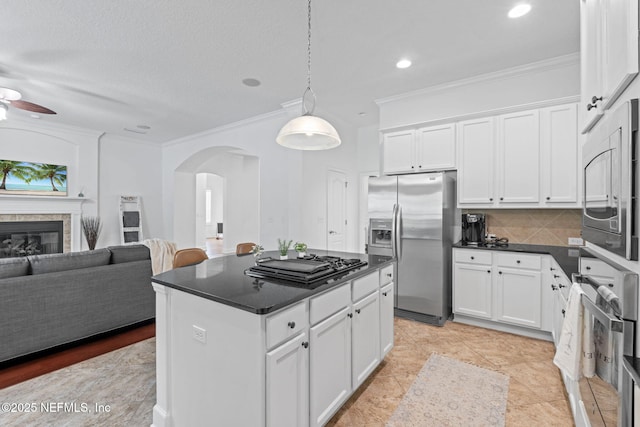 kitchen with white cabinets, stainless steel appliances, and tasteful backsplash