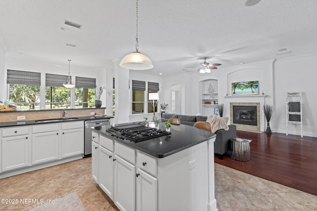 kitchen with gas cooktop, sink, pendant lighting, dishwasher, and white cabinetry