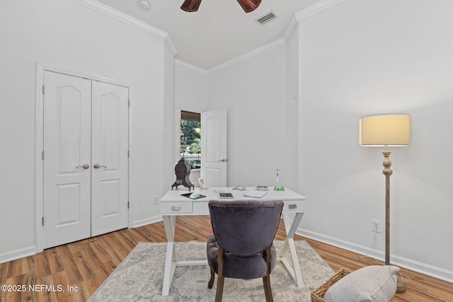 home office featuring ceiling fan, crown molding, and light wood-type flooring